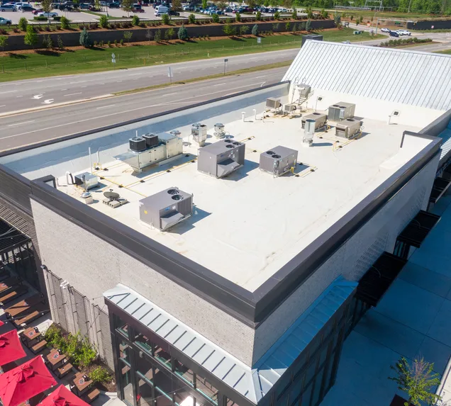 Core Roofing Systems crew installing PVC membrane roofing on a commercial building in Denver