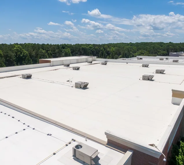 Core Roofing Systems crew installing rolled bitumen roofing on a commercial building in Denver