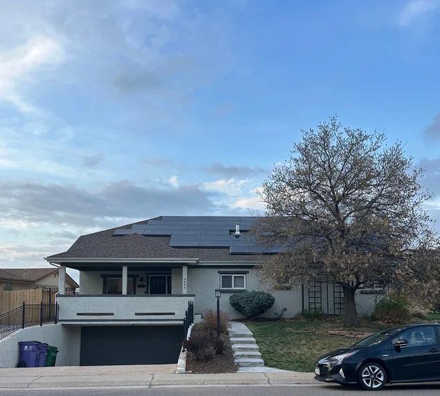 Core Roofing Systems crew coordinating a roof replacement under existing solar panels in Denver