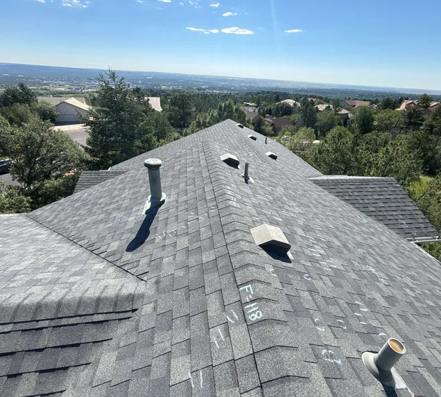 Core Roofing Systems technician evaluating storm damage on a multifamily roof in Denver