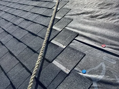 Core Roofing Systems technician inspecting storm damage on a residential roof in Denver